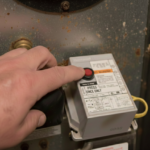 Oil burner reset button location on a residential heating system primary control box